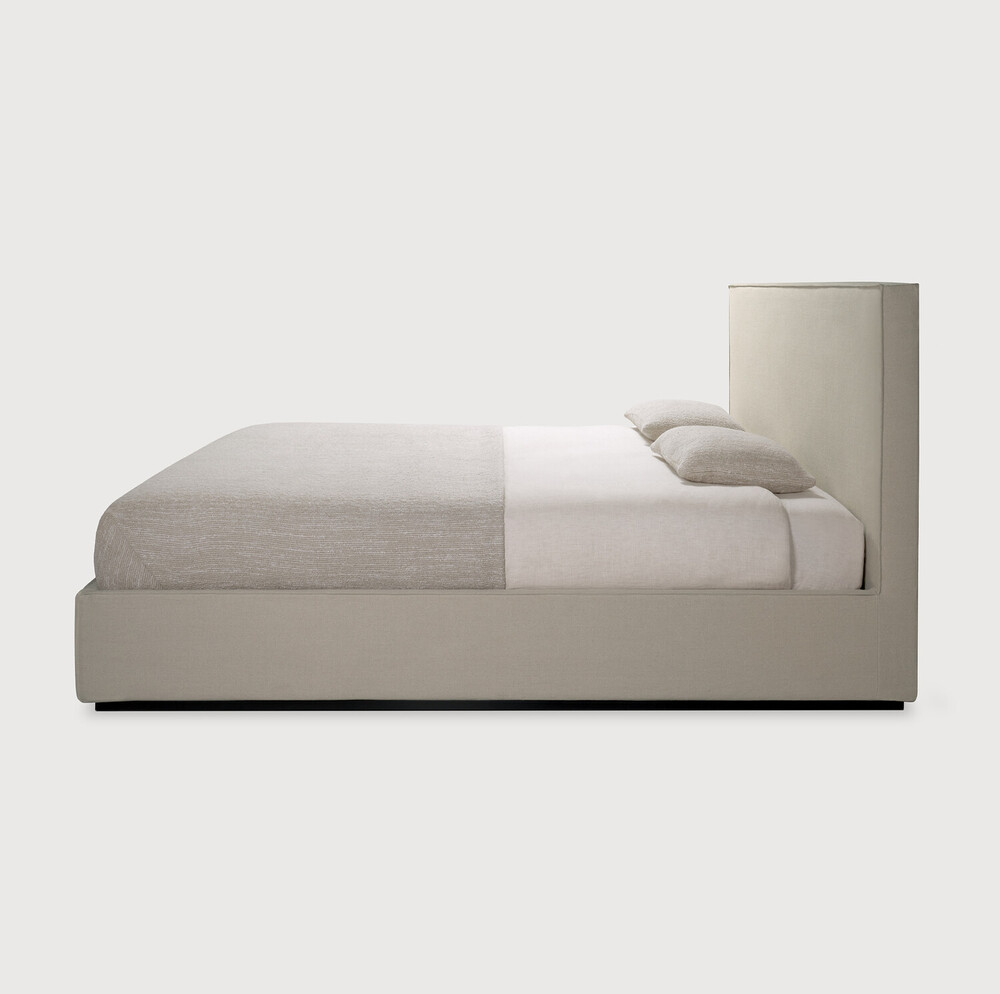 Bed with linen headboard